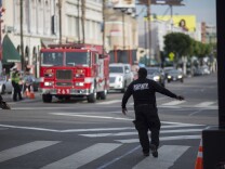 File: A security guard stops pedestrian traffic for an approaching fire truck on Hollywood Boulevard where preparations were being made for the premiere of Walt Disney Pictures And Lucasfilm's "Star Wars: The Force Awakens" on December 13, 2015 in the Hollywood section of Los Angeles.