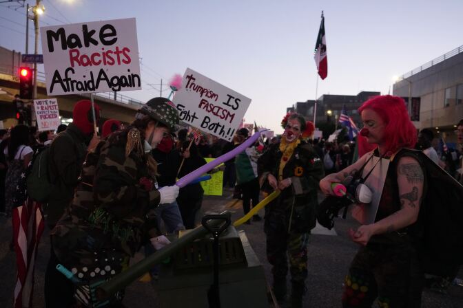  No Kings protesters gather in downtown L.A. as the sun sets.