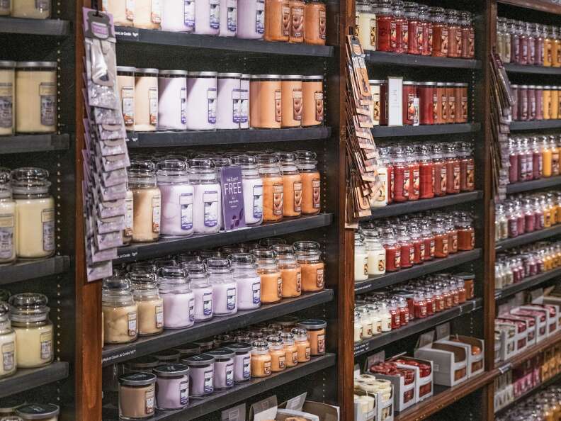 Rows and rows of jarred candles on shelves