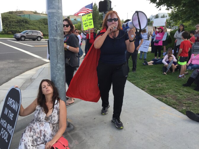 A woman dressed as vampire leads the chant.