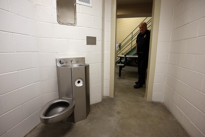 Fremont police Lt. Mark Devine looks into an empty jail cell at the Fremont Police Detention Facility on August 1, 2013 in Fremont, California.