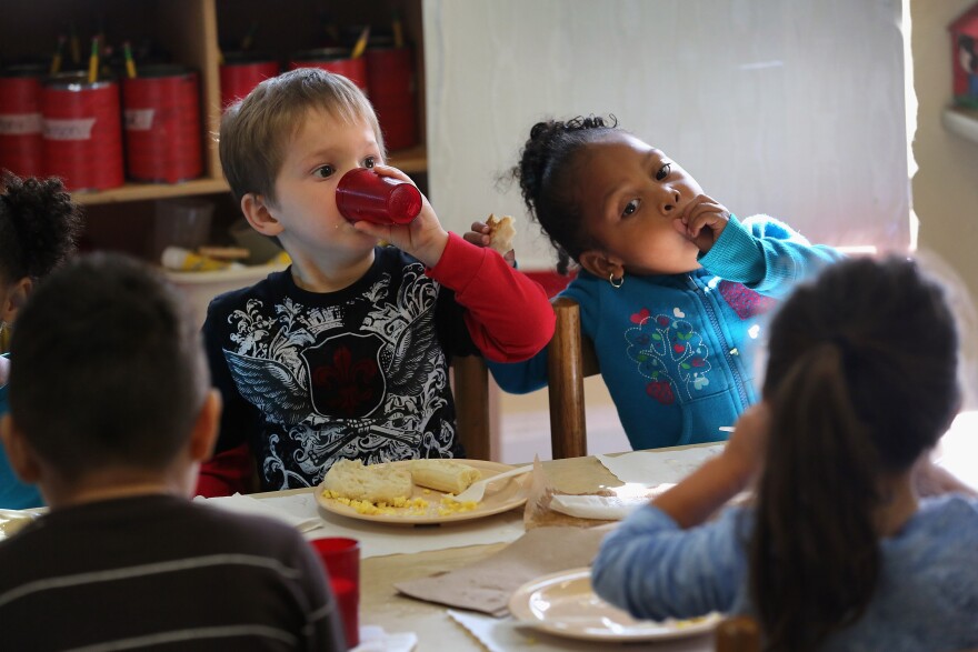 Children eat breakfast at the federally-funded Head Start Program school on September 20, 2012 in Woodbourne, New York. The school provides early education, nutrition and health services to 311 children from birth through age 5 from low-income families in Sullivan County, one of the poorest counties in the state of New York. The children receive 2/3 of their daily nutritional needs through meals, which include breakfast, lunch and snack, that are prepared at the school and served family-style in classrooms. The county Head Start program was expanded with a $1 million grant from President Obama's 2009 stimulus bill, the American Recovery and Reinvestment Act. Head Start, administered by the U.S. Department of Health and Human Services, is the longest-running early education program for children of low-income families in the United States.