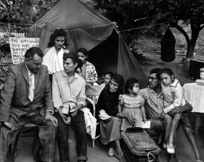 May 1959: "Some, ready to move out of Chavez Ravine, and others not, members of the Manuel Arechiga family listen to the advice of attorney Phil Silver (left) as new developments transpire in the Chavez controversy." Courtesy of the Los Angeles Public Library