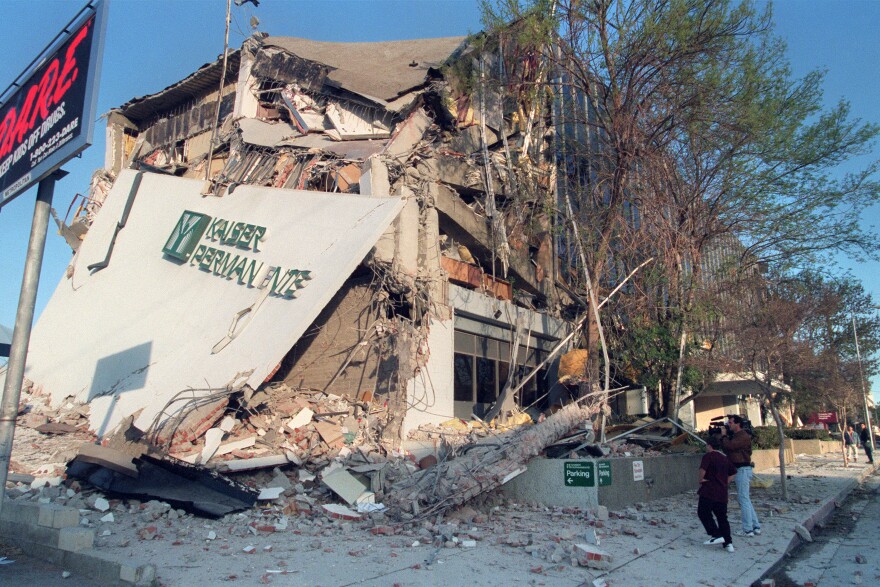 A resident and a cameraman look at damage to the Kaiser Permanente Building following the Northridge earthquake, on January 17, 1994. The earthquake measured 6.6 on the Richter scale and was centered in the San Fernando Valley.