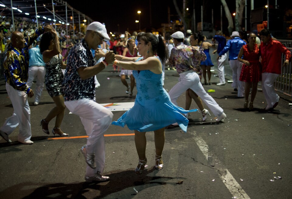 Colombian salsa dancers perform in the "Salsodromo" parade, which marks the start of the 57th Fair of Cali, on December 25, 2014, in Cali, Colombia.