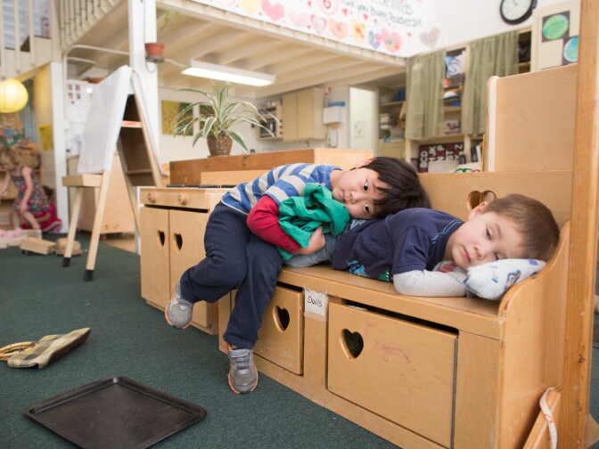 Preschool students take a nap together at the Child Educational Center, which uses an “anti-bias” approach to children’s learning and gender roles.