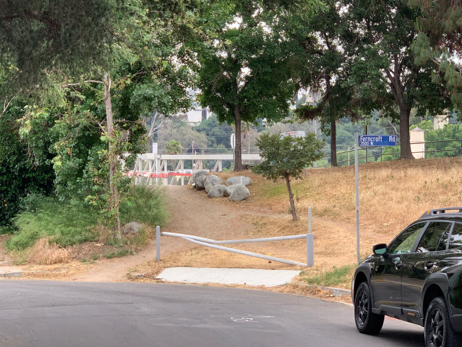 A wooded dirt path leads up into some trees. It looks so unassuming that it could be easily missed. 