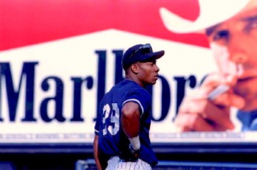 New York Yankees outfielder Gerald Williams waits his turn for batting practice with a Marlboro cigarette billboard in the background in centerfield at Yankee Stadium in New York.