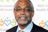 A light-skinned Black man with glasses, a short-cropped salt-and-pepper beard, and short-cropped salt-and-pepper hair, smiles at the camera.