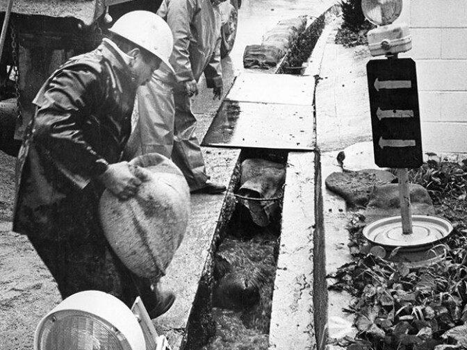 April 8, 1965: Workers place sandbags in an unfilled telephone cable ditch on Laurel Canyon Blvd. near Lookout Mountain Ave. after rains threatened to wash away portions of the street weakened by the excavation. (Photo courtesy of the Los Angeles Public Library)