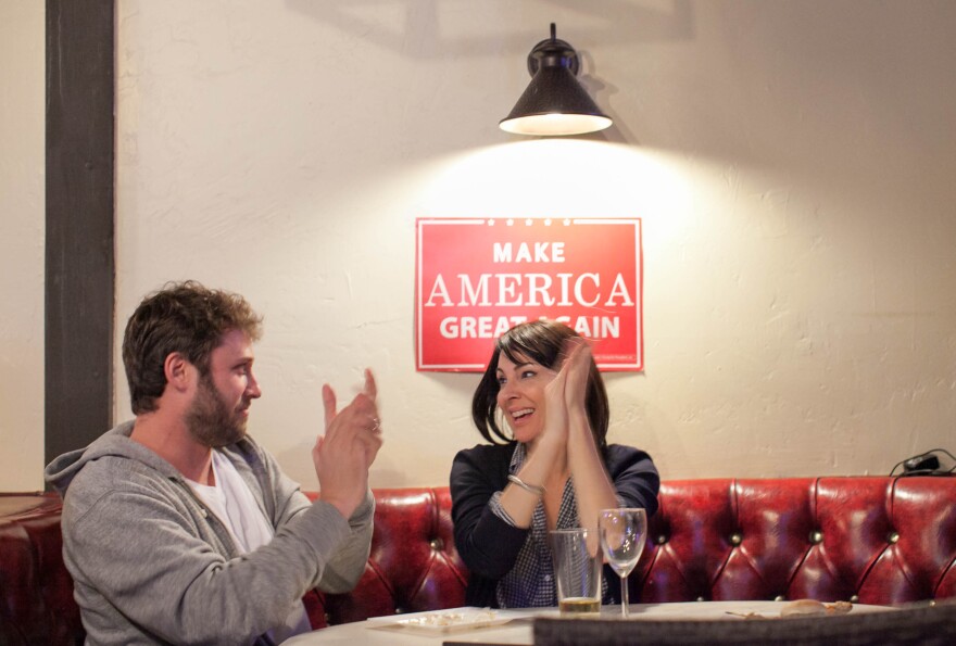 Adam White and his wife, Stephanie Wheeler-White, react during the second presidential debate at JJ's Bar & Grill in Santa Clarita, Calif. on Sunday, Oct. 9, 2016.