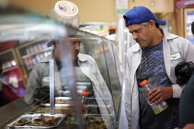 A customer waits for his order at Poncitlan Burrito Express. Since first opening in 1992, major grocery stores Walmart and Super King have moved into Altadena.