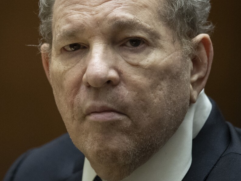 Close-up of face of older man with light-skin tones in a suit.
