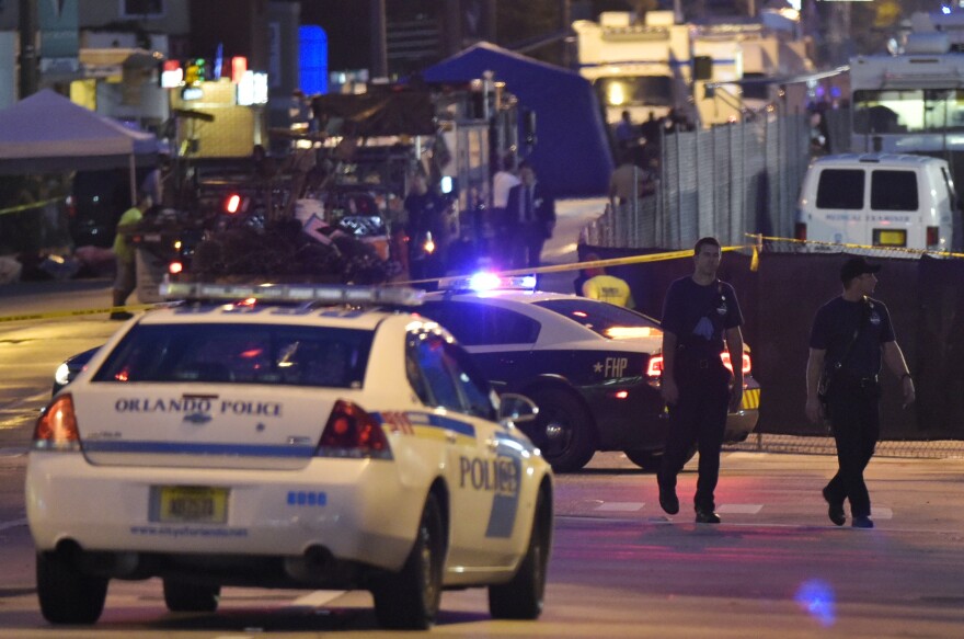 Lights from police vehicles light up the scene infront of the Pulse club in Orlando, Florida on June 12, 2016. 
