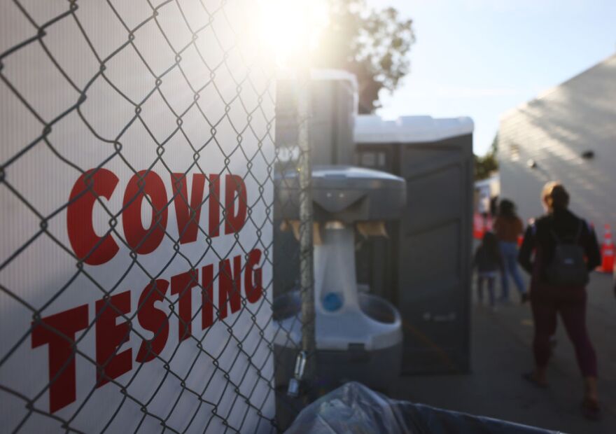 SAN FERNANDO, CALIFORNIA - DECEMBER 2: People walk to enter a COVID-19 testing site on December 2, 2020 in San Fernando, California. California reported 20,759 new coronavirus cases today, a one-day record for the state, amid a new limited stay-at-home order in Los Angeles County. (Photo by Mario Tama/Getty Images)