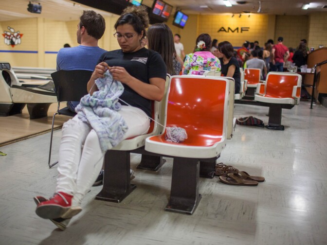Desiree Escarcida knits between frames at the AMF lanes in Fullerton, Calif.