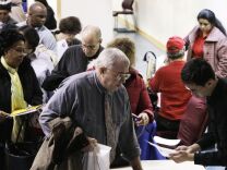 John Pham (right) reviews Bob Drake's resume at an AARP event intended to help older workers improve their job search. 
