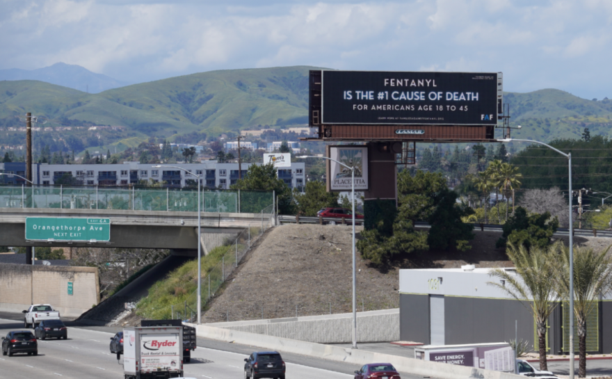 A billboard over a freeway reads "Fentanyl is the #1 cause of death for Americans age 18 to 45."