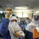 SAN JOSE, CALIFORNIA - MAY 21: (EDITORIAL USE ONLY) A nurse writes a note on a window as a team of doctors and nurses performs a procedure on a coronavirus COVID-19 patient in the intensive care unit (I.C.U.) at Regional Medical Center on May 21, 2020 in San Jose, California. Frontline workers are continuing to care for coronavirus COVID-19 patients throughout the San Francisco Bay Area. Santa Clara county, where this hospital is located, has had the most deaths of any Northern California county, and the earliest known COVID-19 related deaths in the United States. (Photo by Justin Sullivan/Getty Images)