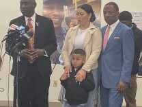 Attorney Ben Crump stands speaks to reporters to announce a $50 million claim filed against the City of Los Angeles in the case of Keenan Anderson.  He is joined by Gabrielle Hansell, the mother of Anderson's five-year-old son. 