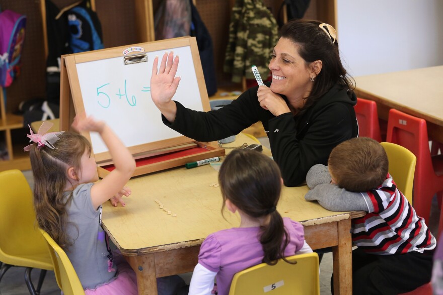Teacher Denise Severing congratulates a child during a math lesson at the federally-funded Head Start school on September 20, 2012 in Woodbourne, New York. A California judge has struck down  teacher tenure protection, seniority-based job protection and existing disciplinary policy in a groundbreaking case for education equality.