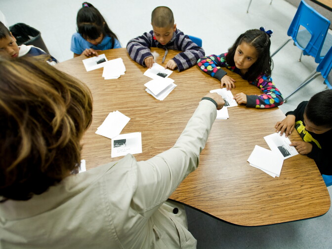 Teacher Susan Lopez reads a story along with her transitional kindergarten students.