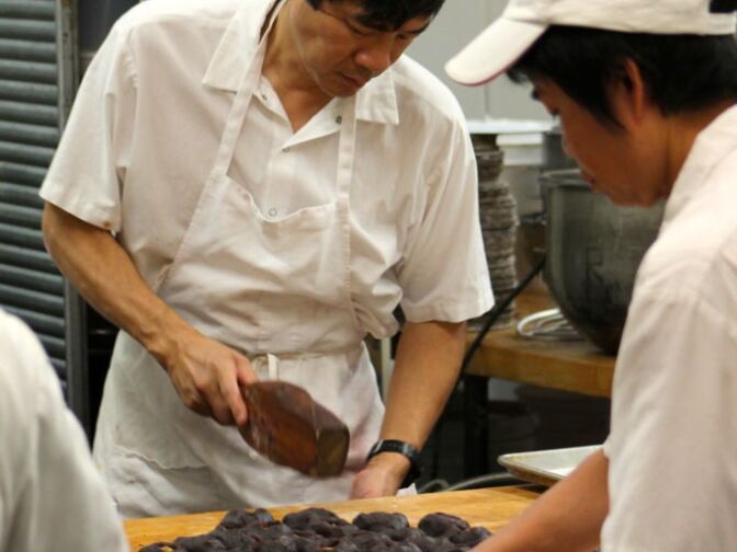 Then, the moon cakes are pounded out of the mold and later placed in the oven.