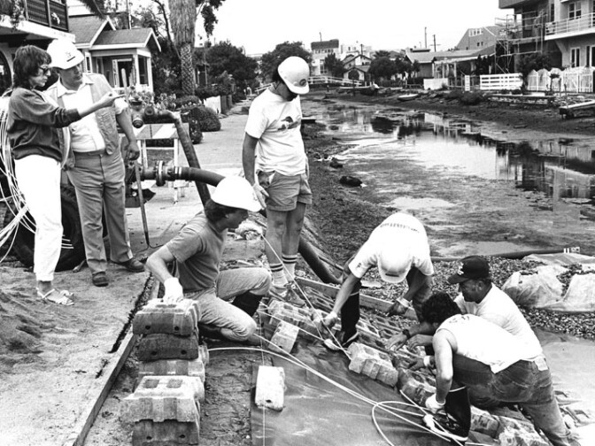 Councilwoman Ruth Galanter watches crew put a Armorflex lining in the Venice canals in 1988.