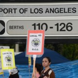 Striking workers carry placards December 4, 2012 at the Port of Los Angeles in southern California. Commerce could be brought to a near standstill at major ports from Boston to Houston if a strike takes place on Sunday, potentially delivering a big blow to retailers and manufacturers still struggling to find their footing in a weak economy.