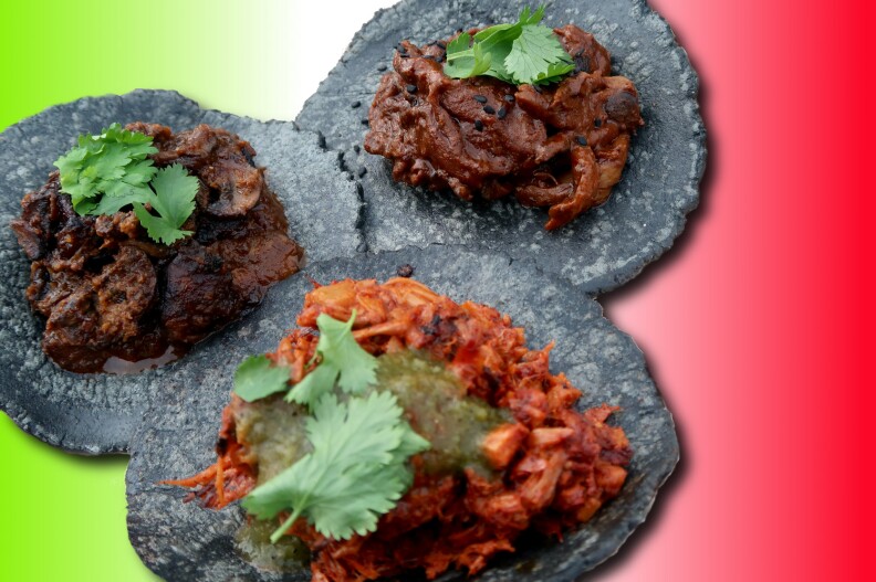 three tacos on blue corn tortillas set against a green, white and red background like the Mexican flag.