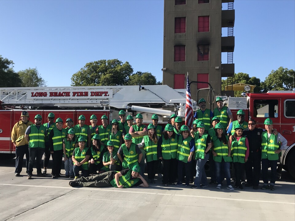 The entire group of 32 CERT trainees and program manager Jake Heflin in his firefighting uniform on the far left. More than 1,000 people have graduated from CERT programs in Long Beach since they started. Photo credit: Audrey Alden