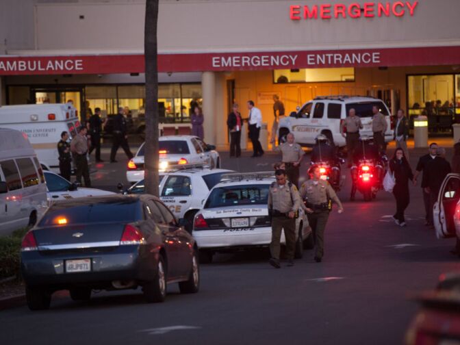 Police wait outside Loma Linda hospital, where two Sheriff's Deputies were brought Tuesday after a man police believe to be Christopher Dorner allegedly shot them.