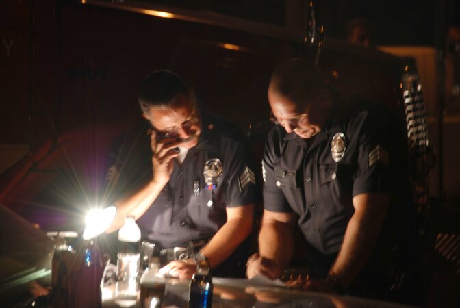 Police officers undergo an investigation on September 13, 2008.