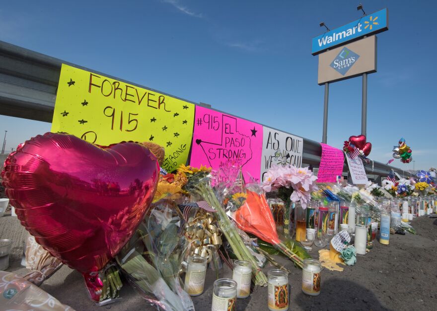 Flowers and signs at a makeshift memorial after the shooting that left 21 people dead at the Cielo Vista Mall WalMart in El Paso, Texas, on August 5, 2019. - US President Donald Trump on Monday urged Republicans and Democrats to agree on tighter gun control and suggested legislation could be linked to immigration reform after two shootings left 30 people dead and sparked accusations that his rhetoric was part of the problem. "Republicans and Democrats must come together and get strong background checks, perhaps marrying this legislation with desperately needed immigration reform," Trump tweeted as he prepared to address the nation on two weekend shootings in Texas and Ohio. "We must have something good, if not GREAT, come out of these two tragic events!" Trump wrote. (Photo by Mark RALSTON / AFP)        (Photo credit should read MARK RALSTON/AFP/Getty Images)