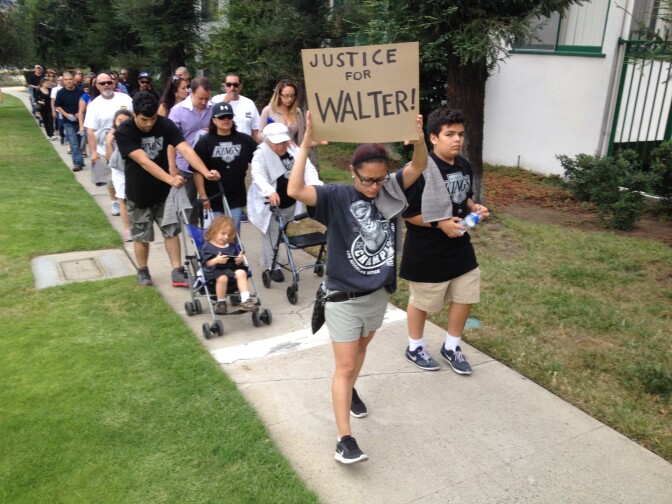 Walter DeLeon's niece, Zulema Pivaral, leads a protest walk along Los Feliz Boulevard in Los Feliz. DeLeon was shot and critically wounded by an LAPD officer June 19. He was unarmed.