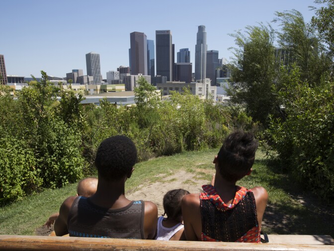 Stephanie Williams, 20, and partner Robery Lewis, 27, with baby Rieley Lewis, 9 months, and daughter Kylee Lewis, 2, enjoy the view of downtown from Vista Hermosa Natural Park, Los Angeles on 20th June 2016. Stephanie earned her high school diploma this June through Project NATEEN at Children's Hospital Los Angeles. 