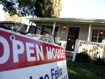 In this Nov. 4, 2010 photo, signs are posted for an open house on the front lawn of a home for sale in Los Angeles. Sales of previously owned homes slipped slightly in October as the housing market struggled in the face of high unemployment and tight credit. (AP Photo/Richard Vogel)