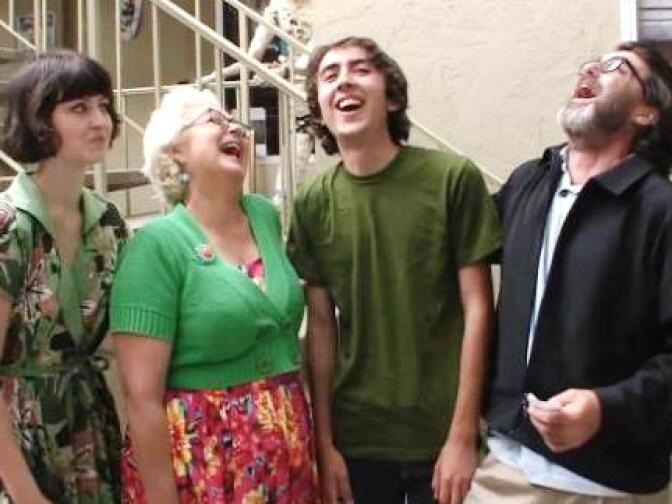 Daughter Lulu, wife Mimi Pond, son Woodrow, and Wayne White in a screengrab from the new documentary about Wayne, "Beauty is Embarassing." (Lulu also laughs; just not in this shot.)