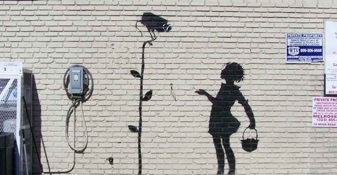 This undated publicity photo released by Julien's Auctions shows the Banksy graffiti mural entitled, "Flower Girl," which formerly occupied a gas station in Los Angeles. The mural headlines Julien’s Auctions “Street Art” auction to take place Thursday, December 5, 2013, in Beverly Hills, Calif. 