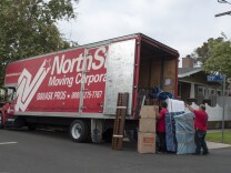 Movers from NorthStar Moving Corporation load a truck with possessions from a newly sold home in Central Los Angeles.
