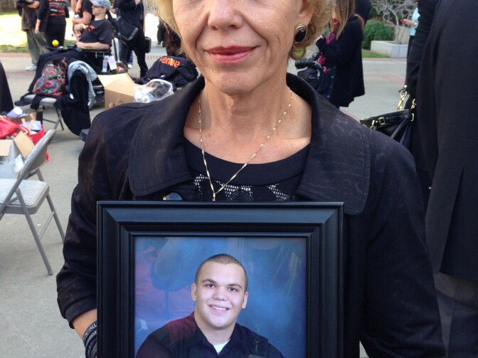 Tammy Smick holds a photograph of her son, Alexander, who died February 23, 2012 of an overdose. Smick told lawmakers the doctor who prescribed the lethal drugs practices medicine in Long Beach.
