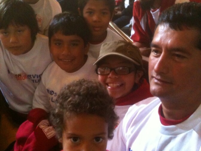 Jazlyn Landeverde, 10, sits smiling in the middle of her Stoner Park soccer team at Los Angeles City Hall, where she and her teammates were protesting cuts to the city's Recreation and Parks Department.