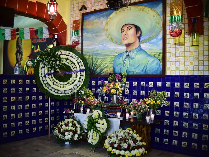 View of an altar with flowers in a mural depicting the late Mexican singer Juan Gabriel inside a restaurant in the Plaza Garibaldi in Mexico City, on August 29, 2016.