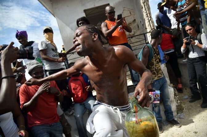 A devotee dances in a trance during a ceremony honoring the Haitian voodoo spirits of Baron Samdi and Gede on the Day of the Dead in the National Cemetery in Port-au-Prince, Haiti on November 1, 2016.