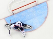 US goalkeeper Jonathan Quick stops the puck during the Men's Ice Hockey Group A match between Slovakia and the United States at the Shayba Arena during the Sochi Winter Olympics on February 13, 2014.