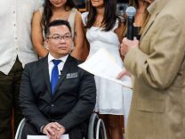A man in suit sitting in a wheelchair 