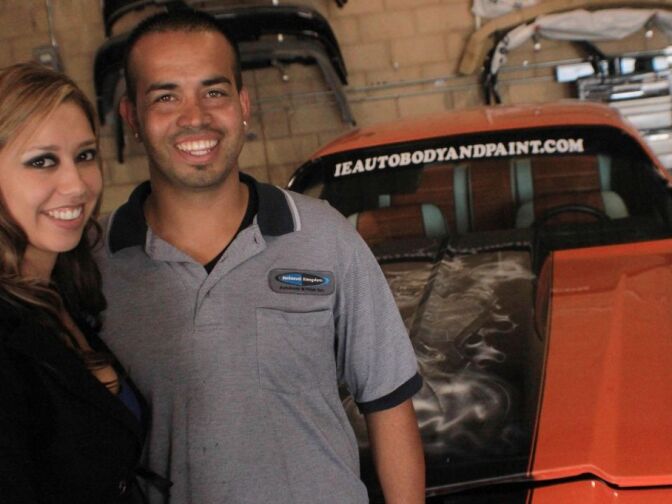 
Lucy and Isaac Gallardo in their Riverside auto body shop alongside the prize winning 1971 Camaro their crew restored on the Speed Network reality show “Car Warriors.” 
