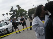 Police and local residents gather near the house of Lonnie Franklin Jr., 57, in South Los Angeles. 