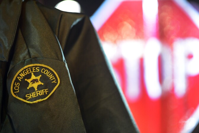 A Los Angeles Sheriff's Department deputy's jacket hangs near a stop sign at a DUI checkpoint in Bellflower Thursday evening near the intersection of Woodruff Avenue and Alondra Boulevard.