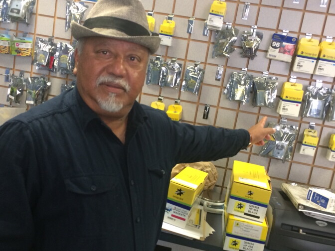 Omar Huda, 65, points out printer supplies in his Pasadena store. He says his family's shrimp business in Bangladesh was destroyed after a 2007 cyclone, forcing his cousins to the capital, Dhaka. 